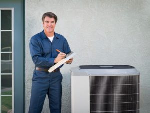 Hvac Contractor Standing Next To Air Conditioner