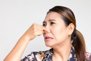 Woman Holds Nose Because Of Bad Smell