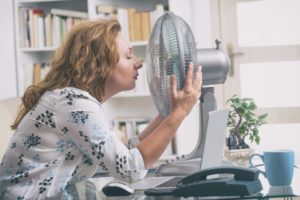 Woman With Fan In Her Face