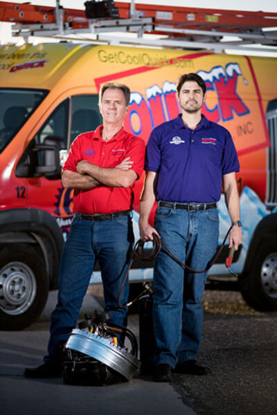 Quick Refrigeration team members standing in front of service truck